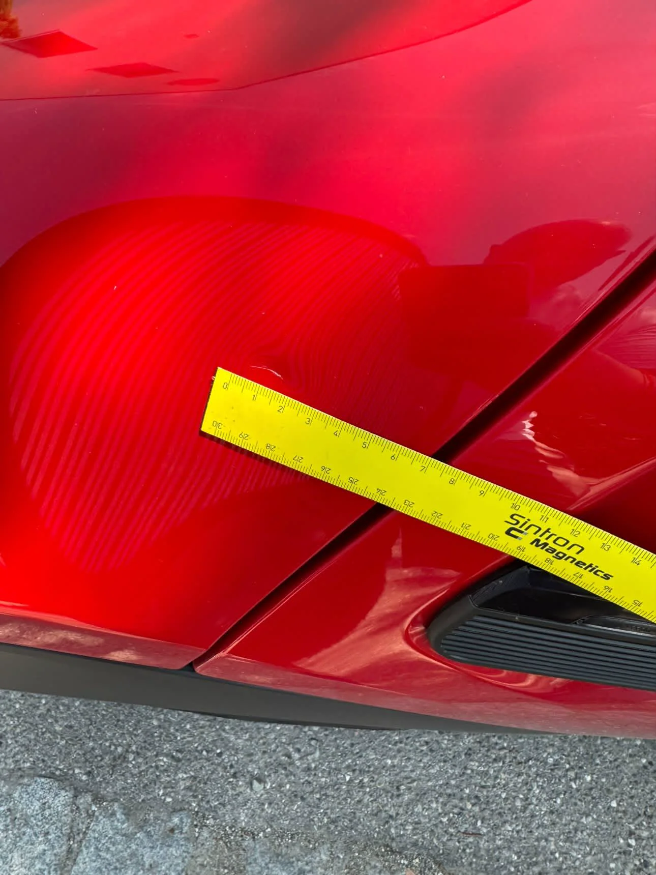 Dokumentierte Delle am roten Mini Cooper mit Messlineal